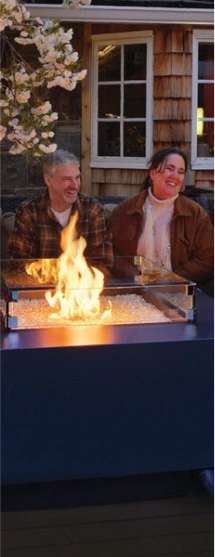 Couple sitting outside by fire