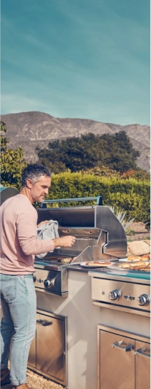 man standing in front of grill